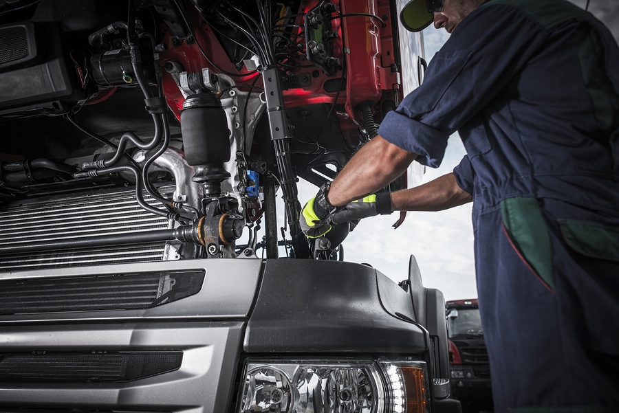 Repairing Broken Semi Truck Tractor Engine. Caucasian Trucks Mechanic